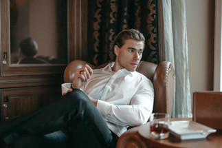 groom getting ready at cigar room in Villa Honegg Switzerland