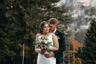 Bride and groom holding each other after their in the mountains in the alps in Murren, Switzerland