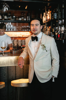 Groom posing by the bar Cervo hotel in Zermatt. Destination wedding in Zermatt, Switzerland.