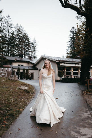 Bride walking on the path towards the lake at the Blausee
