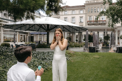 A luxury marriage proposal in Zurich, Switzerland at 5 stars hotel Baur au Lac: girlfriend covers her mouth in surprise