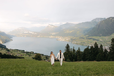 Couple walking from the lake and mountains in front of the hotel Villa Honegg on their marriage proposal photoshoot, in Switzerland