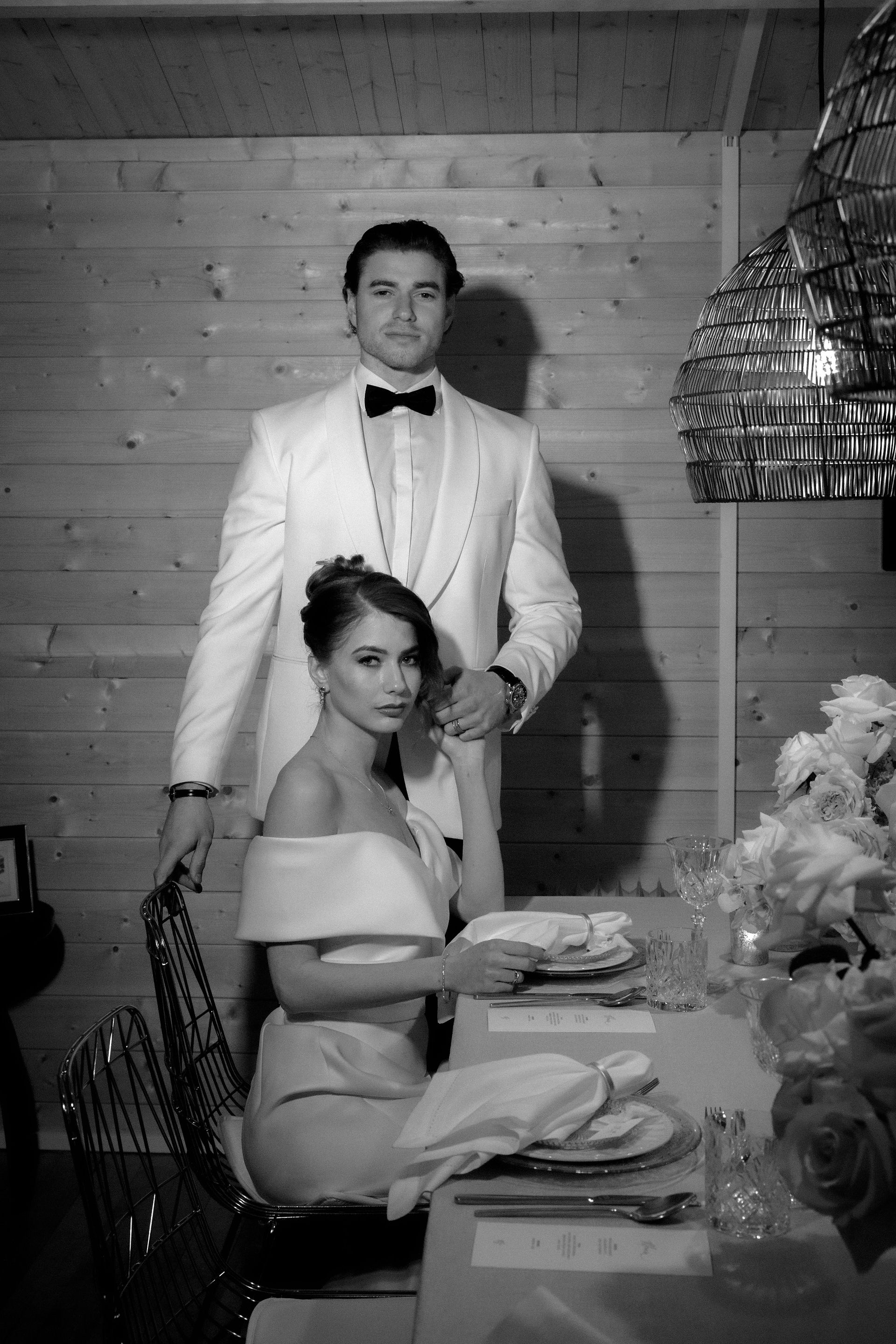 couple posing by a table set for a fondue 