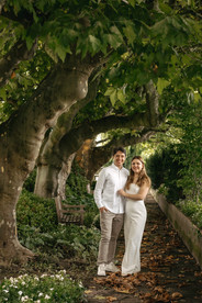 A luxury marriage proposal in Zurich, Switzerland at 5 stars hotel Baur au Lac with Tiffany and co diamond ring: couple posing under the trees