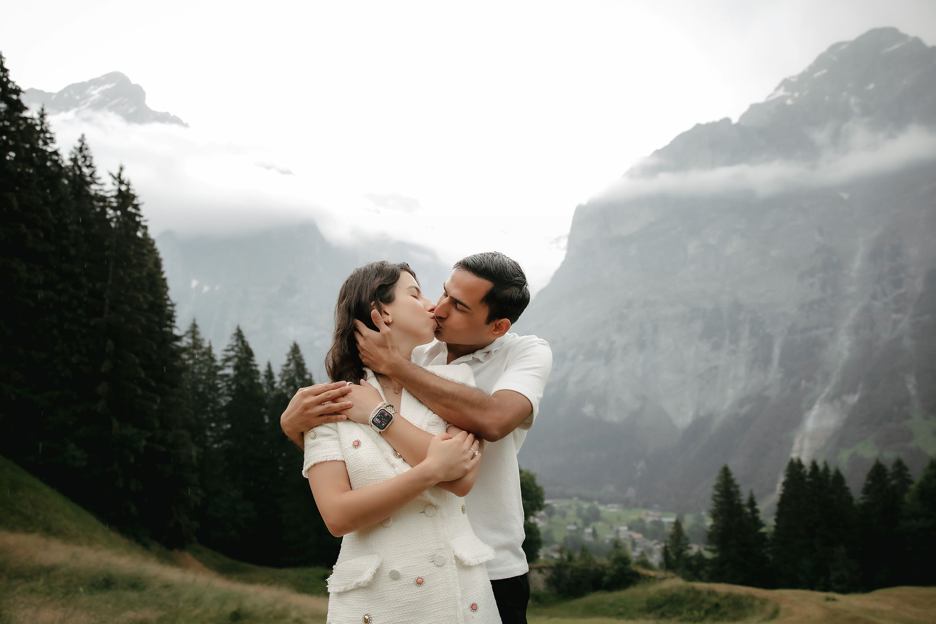 Adventurous proposal in Grindelwald Bort, at a private location in front of the Eiger.  Couple kissing in front of the mountains. 