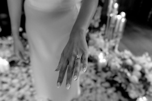 Black and white close up picture of a female hand with engagement ring after saying yes during her marriage proposal at the cigar room in Villa Honegg, Switzerland