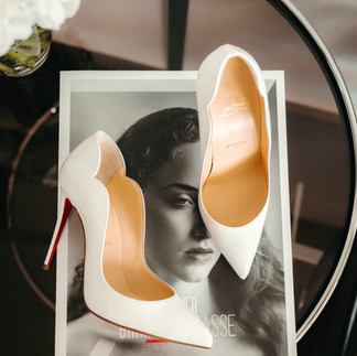 Louboutin heels on the table on top of a magazine at the suite at Dolder Grand hotel, in Zurich