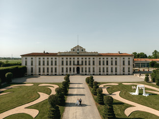 Drone picture outside in front of the building Bride and groom on a wedding day in villa arconati, milan, italy
