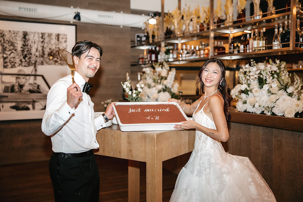 Bride and groom posing with their wedding cake, a tiramisu, at cervo Zermatt in Switzerland
