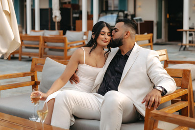 Couple kissing on a bench with champagne glasses in Villa Honegg, after their marriage proposal