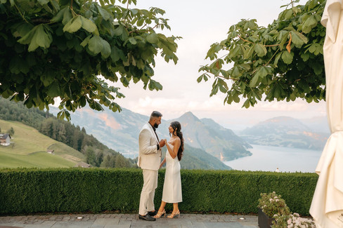 Couple holding hands in front of the hotel Villa Honegg on their marriage proposal photoshoot, in Switzerland