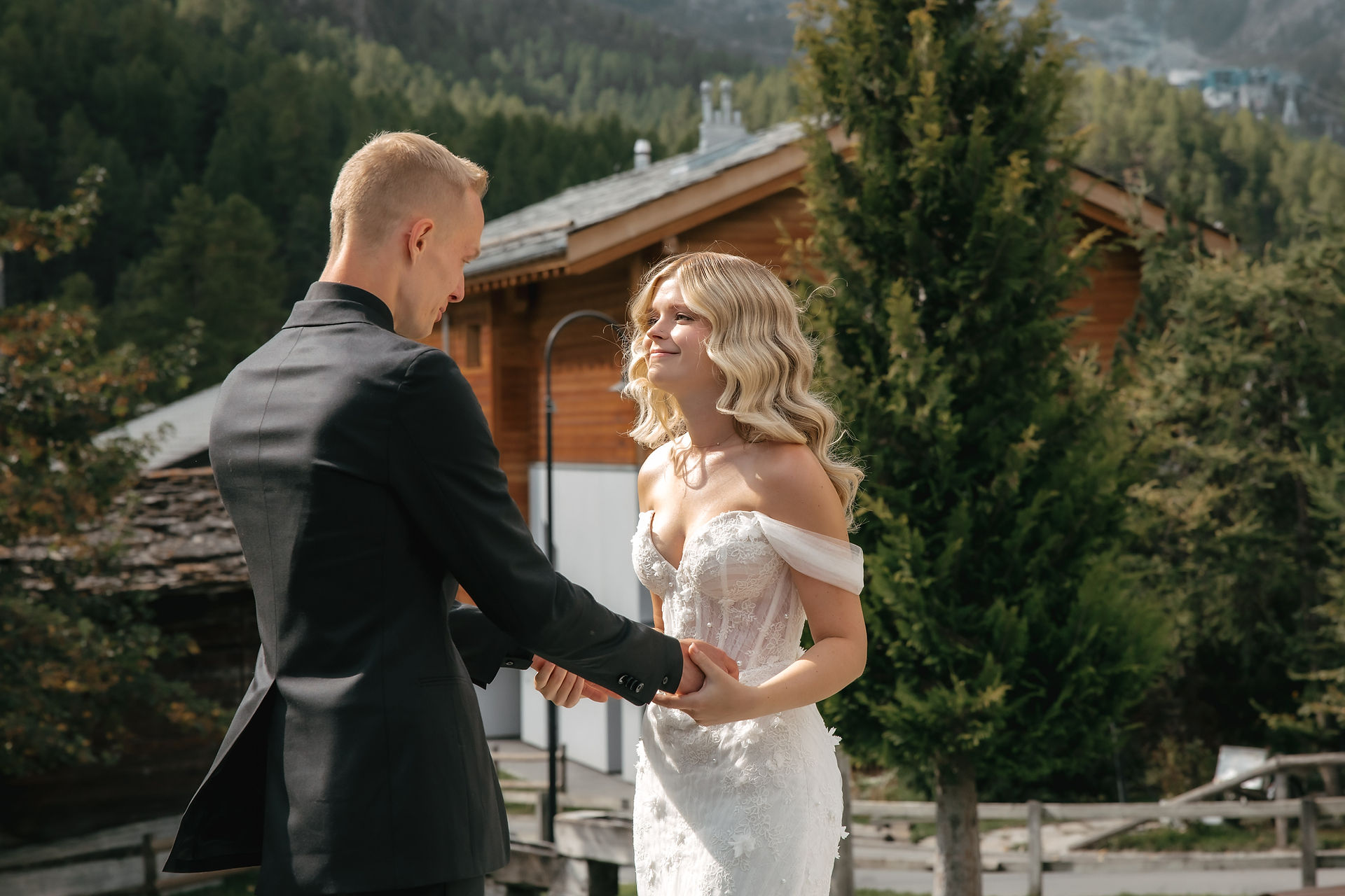 bride and groom first look in front of a chalet of the swiss alps zermatt