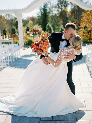 Katie and Alex share a kiss during their wedding ceremony. Photo courtesy of Addy Rae Photography.