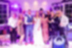 Bride and Groom, Callie and Brandon, pose with Central City Orchestra at their wedding reception. Photo courtesy of Tara Card Photography. 