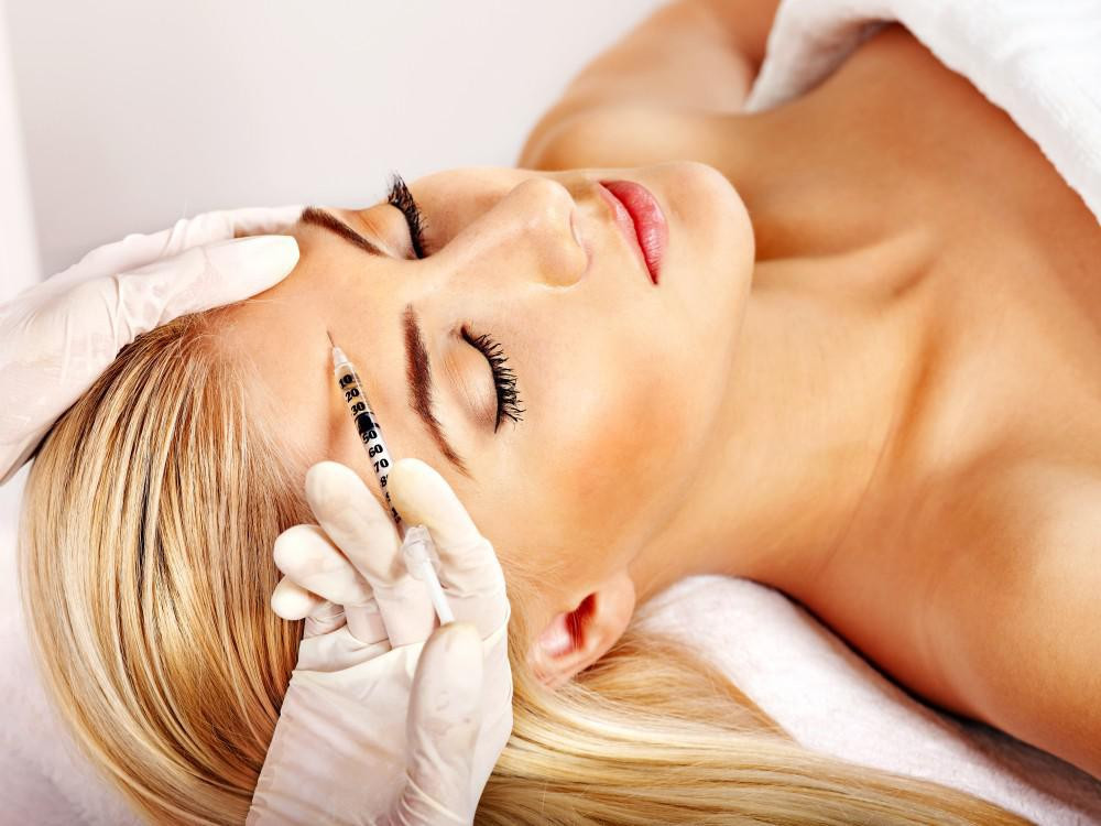 Woman receiving injections to her forehead