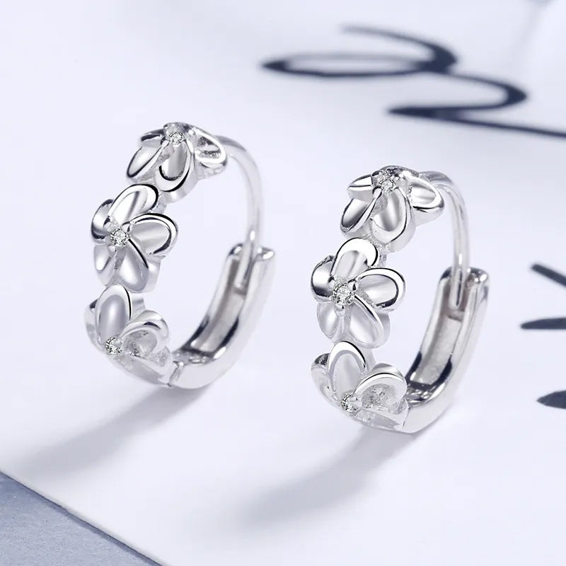 Thumbnail: Kensington Triple Blossom Huggie Earrings in White Gold Finish