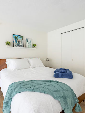 Spacious loft bedroom at The Spot Yaletown with floor-to-ceiling windows and city views