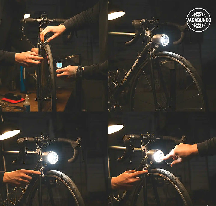 Montage eines Fahrradlichts mit 'VACUUM' auf dunklem Fahrrad.