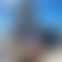 Man and woman posing in front of a historic building