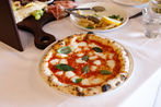 Sneaky's Margherita Pizza with a tomato base, fior di latte, and basil