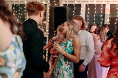 Guests mingling at a wedding reception at Sneaky's Restaurant.