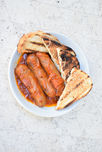 Sneaky's house made Italian sausages, served in Napoletana sauce with continental bread.