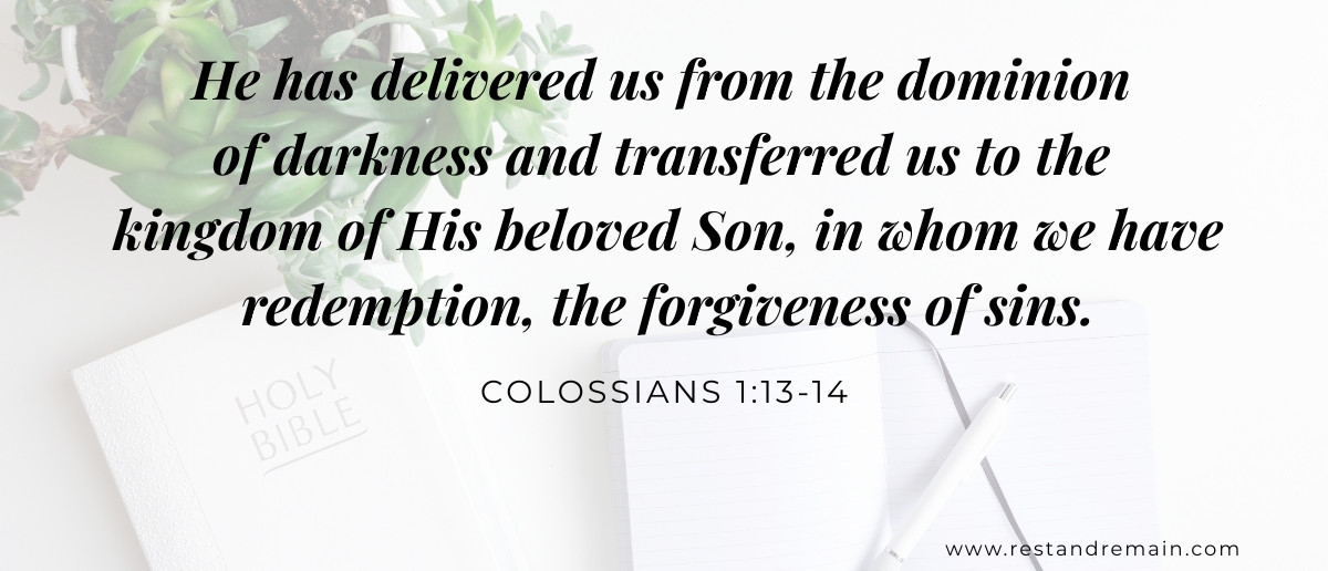 A closed Holy Bible and open journal on a white table, representing Colossians 1:13-14 and being rescued and redeemed in Christ.