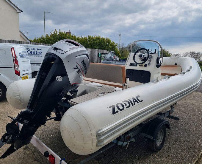 A Zodiac Medline 500 boat in white and tan with hypalon tubes and a Mariner 75hp outboard on a trailer outside Rob Perry Marine in Axminster, Devon
For more photos please click the link below:-