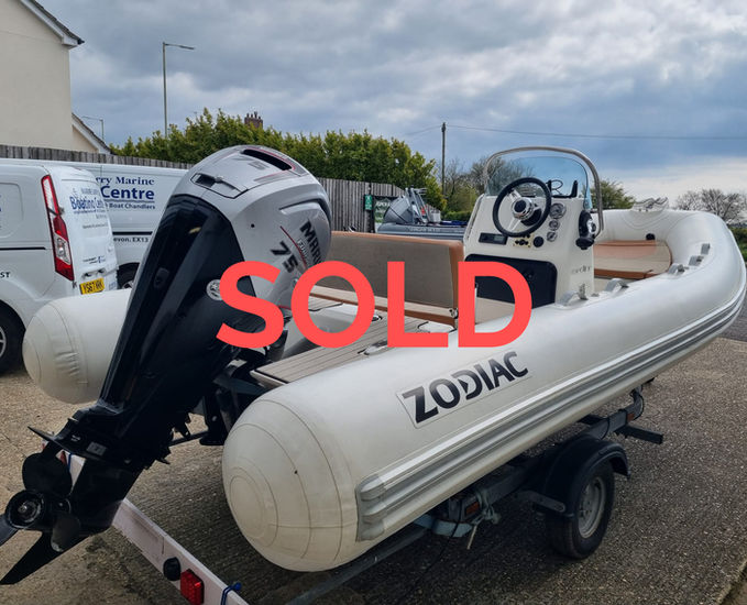 A Zodiac Medline 500 boat in white and tan with hypalon tubes and a Mariner 75hp outboard on a trailer outside Rob Perry Marine in Axminster, Devon
For more photos please click the link below:-