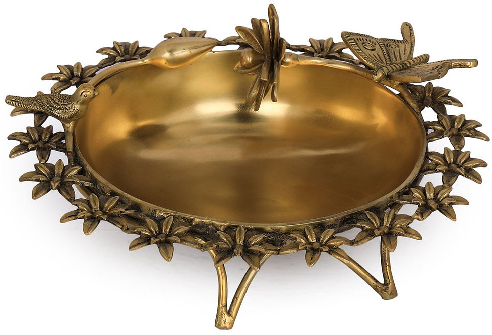 Thumbnail: Bronze designer Urli surrounded by flowers and birds
