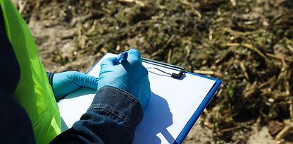 man-examines-pollution-reservoir-takes-notes.jpg