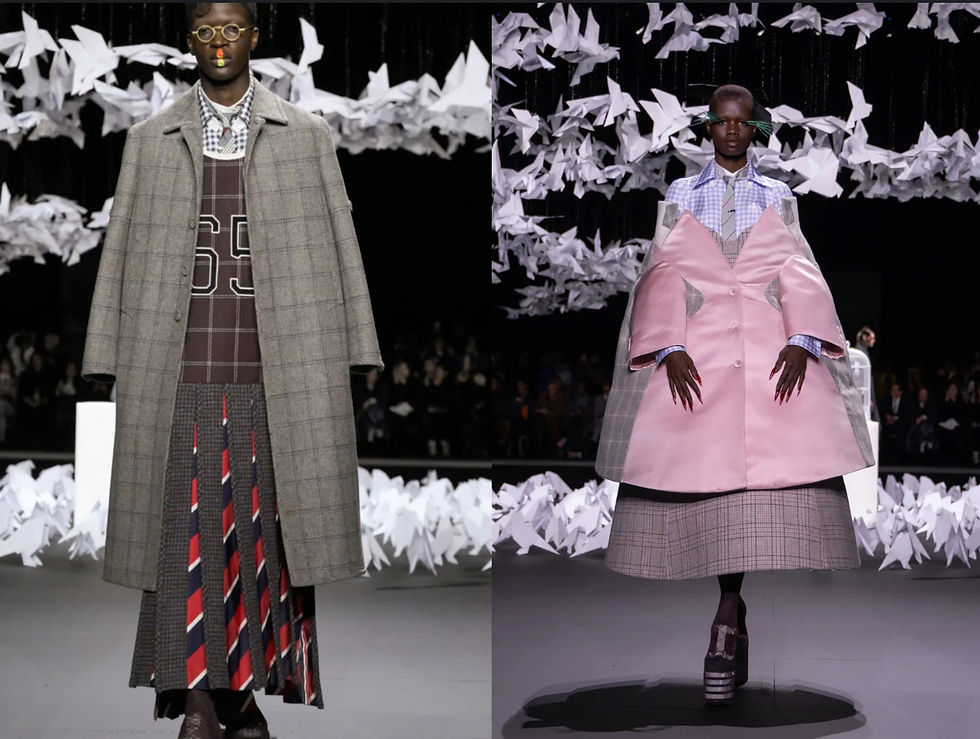 New York Fashion Week Highlights: Models on the iconic Thom Browne runway in patterned coats, one plaid with number 65, another pink and plaid. Origami birds hang overhead, creating an artistic setting.