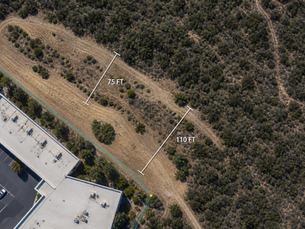 Aerial view of a fuel modification zone with marked clearance areas around a Southern California property