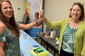 Two women high-five.