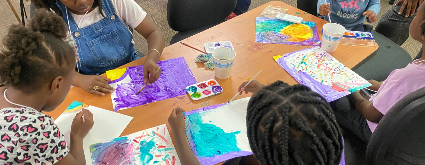 Children paint vibrant artwork together