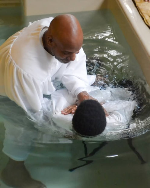 Baptism ceremony: Pastor immersing person in water