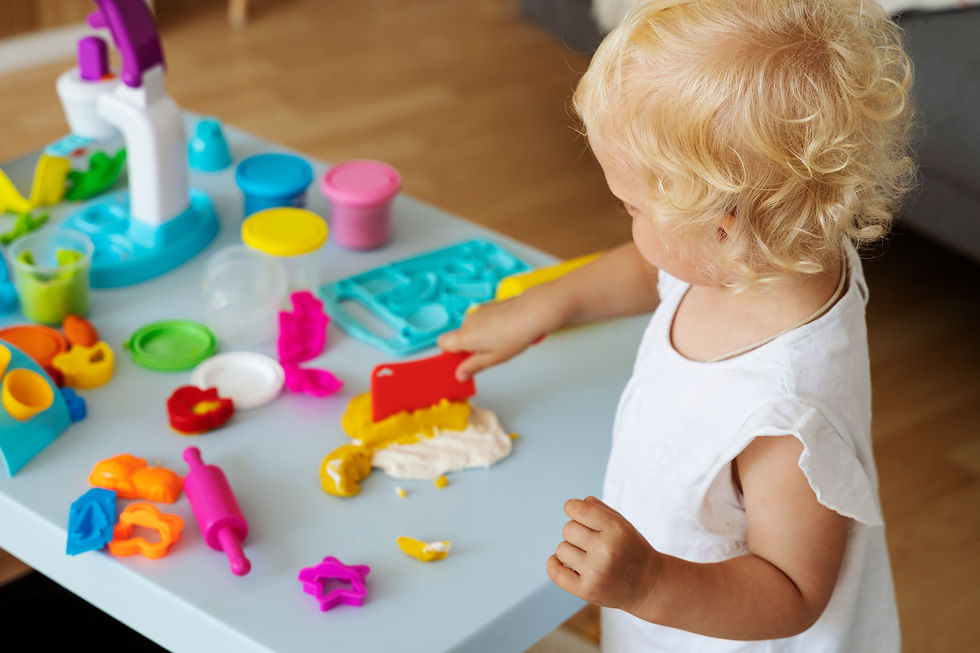 toddler playing with playdough