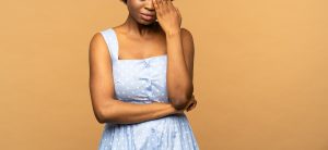 A close up of a black woman wiping a tear away. Learn how trauma consulting in Baltimore, MD can help you address healing fatigue. Learn more about healing from trauma in Baltimore, MD by contacting a trauma therapist in Baltimore, MD today. 