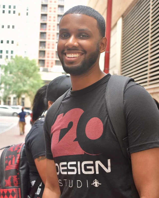 Marshall wearing a 120 Design Studio shirt outdoors.