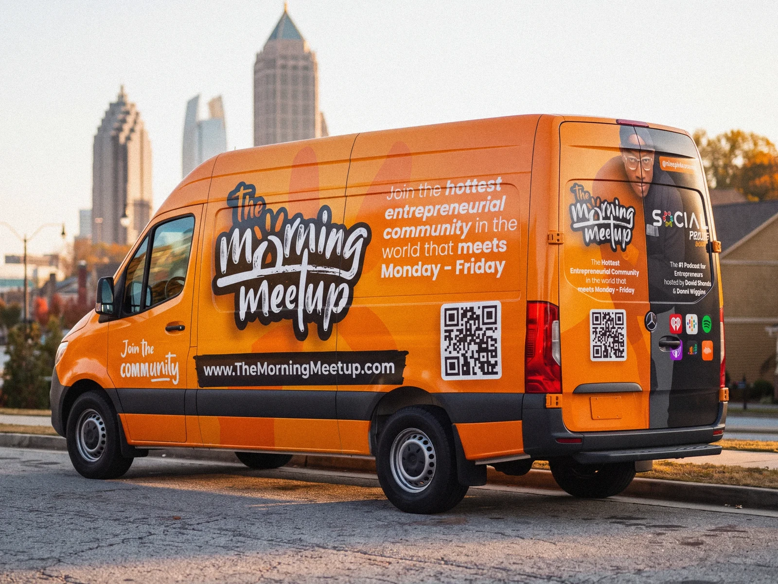 The Morning Meetup orange branded van.