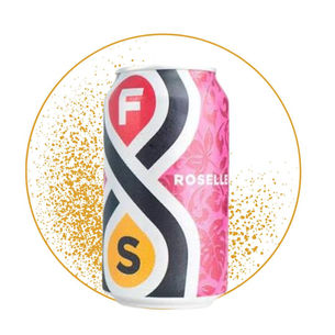 Pink F&S Roselle drink can with floral pattern, centered in a gold-speckled circle on a white background.