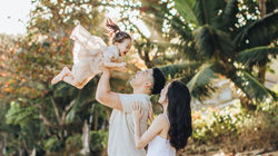 candid photo of a girl being tossed in the air for a photo shoot