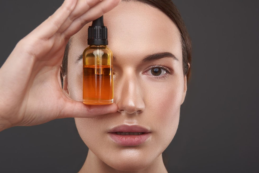 Marula Oil bottle infront of woman face