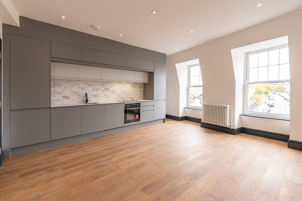 Modern loft conversion kitchen in London with grey cabinets.