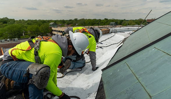C&R Roofing crew installing a commercial roof membrane