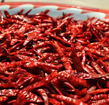 Raw, dried, or cooked, these small but potent peppers pack real heat and are used to add spice to dishes or to make fiery sauces. Red is a fruitier spice profile when compare to the Green one.