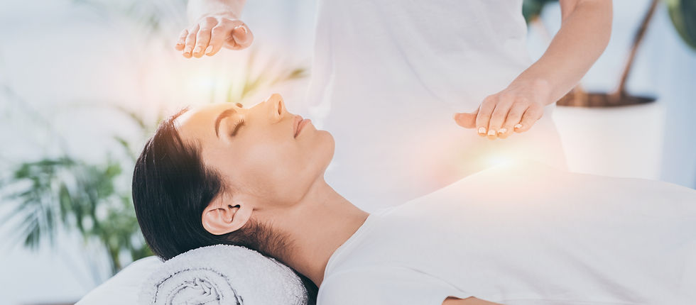 side view of calm young woman receiving reiki healing therapy on head and chest .jpg