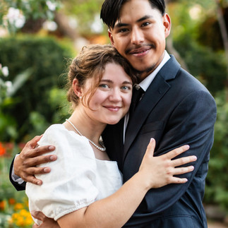 Bride and groom smiling and embracing in natural light at Barrio Garden wedding