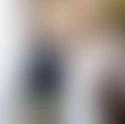 Bride and groom walking up sunlit stairs after exchanging vows