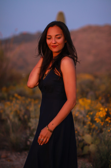 A woman walking in the Tucson desert at sunset